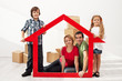 Happy family with kids moving into their new home