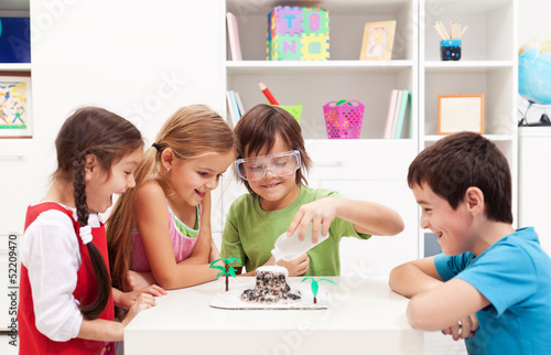 Photo: Kids observing a science lab project at home Kids observing a science lab project at home