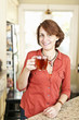 Smiling woman with tea at home