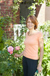 Woman pruning rose bush