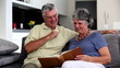 Mature couple looking at a book together