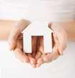 woman hands holding paper house