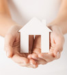 woman hands holding paper house