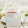 White blank paper, gladiolus flower and tea cup