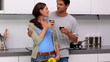 Couple chatting and toasting in the kitchen