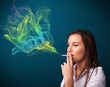 Photo: Pretty lady smoking cigarette with colorful smoke Pretty lady smoking cigarette with colorful smoke