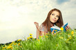 Beautiful girl lies on meadow and reads the boo