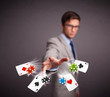 Young man playing with poker cards and chips