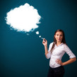 Photo: Young woman smoking unhealthy cigarette with dense smoke Young woman smoking unhealthy cigarette with dense smoke