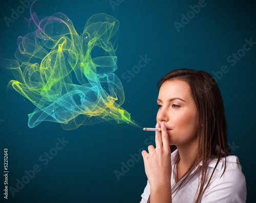 Photo: Pretty lady smoking cigarette with colorful smoke Pretty lady smoking cigarette with colorful smoke