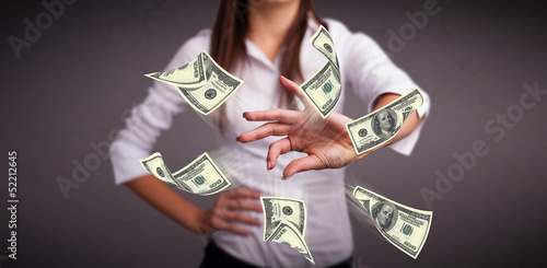 Photo: Young girl throwing money Young girl throwing money