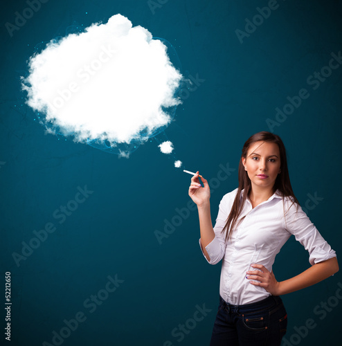 Photo: Young woman smoking unhealthy cigarette with dense smoke Young woman smoking unhealthy cigarette with dense smoke