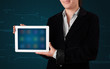 Photo: Woman holding a white tablet with blurry apps Woman holding a white tablet with blurry apps
