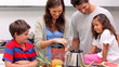 Mother making smoothie for her family