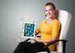 young woman holding tablet with money