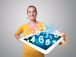 Young woman holding tablet with numbers