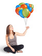Photo: Young woman holding colorful balloons Young woman holding colorful balloons