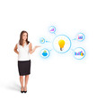 Young woman presenting light bulb with colorful graphs and diagr