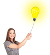 Happy woman holding a light bulb balloon