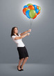 Young woman holding colorful balloons