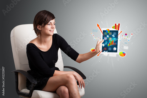 Photo: woman holding modern tablet with colorful diagrams and graphs woman holding modern tablet with colorful diagrams and graphs