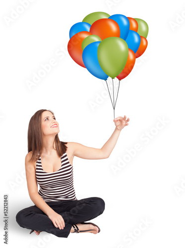 Photo: Young woman holding colorful balloons Young woman holding colorful balloons