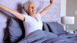 Old woman waking up and stretching