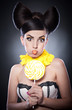 beautiful girl with lollipop and orange slices as earrings.