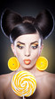 beautiful girl with lollipop and orange slices as earrings.