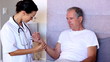 Home nurse checking patients pulse