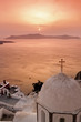 Photo: Santorini with Fira Church against sunset over sea. Santorini with Fira Church against sunset over sea.