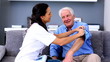 Home nurse checking her patients blood pressure