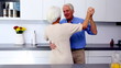 Couple waltzing together in kitchen