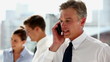 Serious businessman having a phone discussion