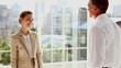 Standing business people shaking their hands