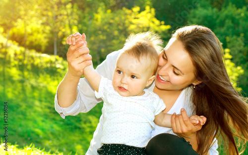 Photo: Beautiful Mother And Baby outdoors. Nature Beautiful Mother And Baby outdoors. Nature