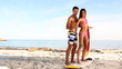 Man teaching to an attractive woman how to surf