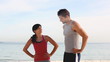 Couple of joggers running on the beach