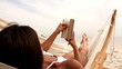 Woman relaxing on her hammock on the beach