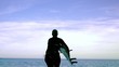 Female surfer running towards the ocean