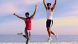 Couple jumping with hands up