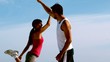 Couple high fiving on the beach