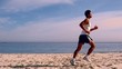 Attractive man running on the beach