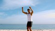 Happy man jumping on the beach
