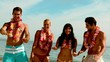 Friends wearing garlands dancing on the beach