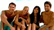 Friends laughing together on the beach