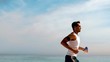Athletic man jogging on the beach