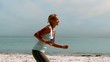 Sportswoman jogging on the beach