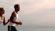 Athletes jogging across the beach