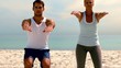 Friends doing pilates on the beach together